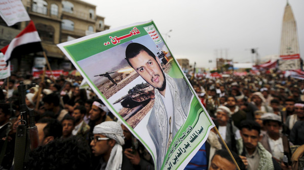 A Houthi follower holds up a poster of the leader of the Houthi group Abdul Malik Badruddin al-Houthi during a demonstration against the Saudi-led air strikes, in Sanaa May 8, 2015. Saudi-led forces carried out air strikes on Friday in Yemen's Saada province, a bastion of Iranian-allied Houthi rebels, and warned all civilians to leave a day after Riyadh promised a harsh response to cross-border Houthi attacks. The poster reads: "We are coming...The leader of the Koranic march Abdul Malik Badruddin al-Houthi." REUTERS/Khaled Abdullah